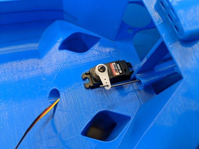 Pushrod fed through the fuselage guide tube