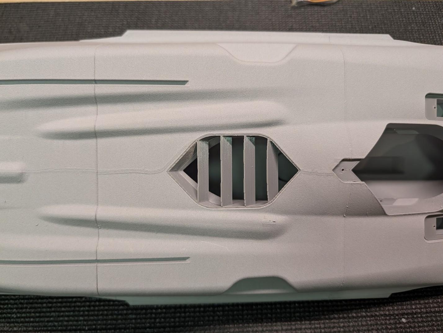 Auxiliary inlet cover on the underside