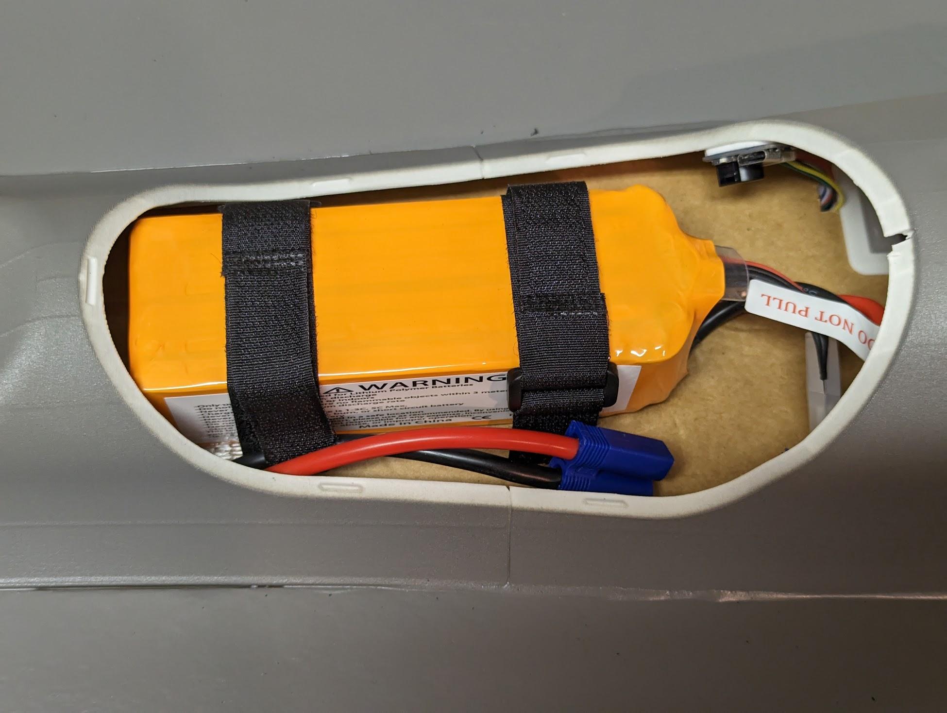 Battery secured with straps