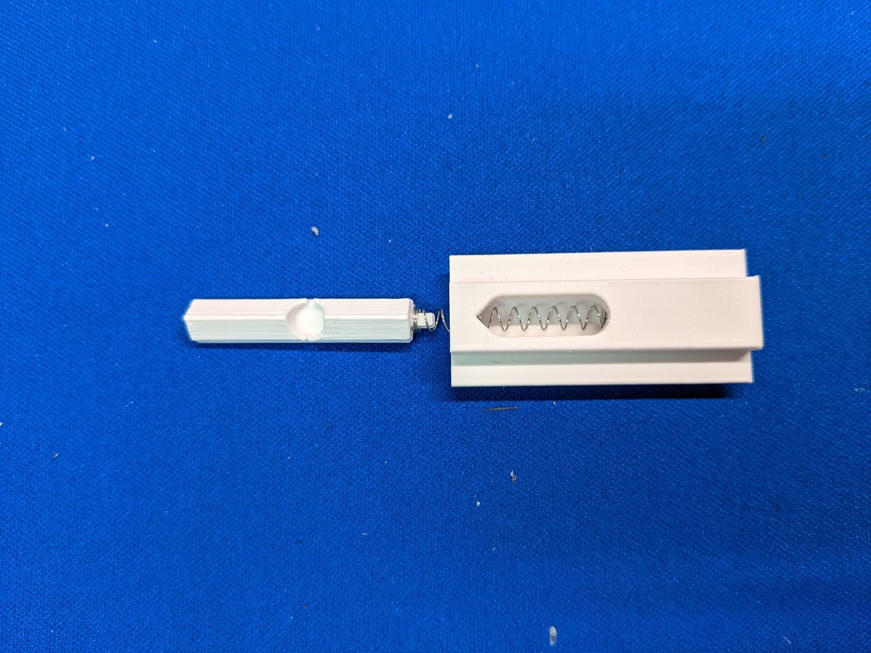 Battery hatch latch and spring
