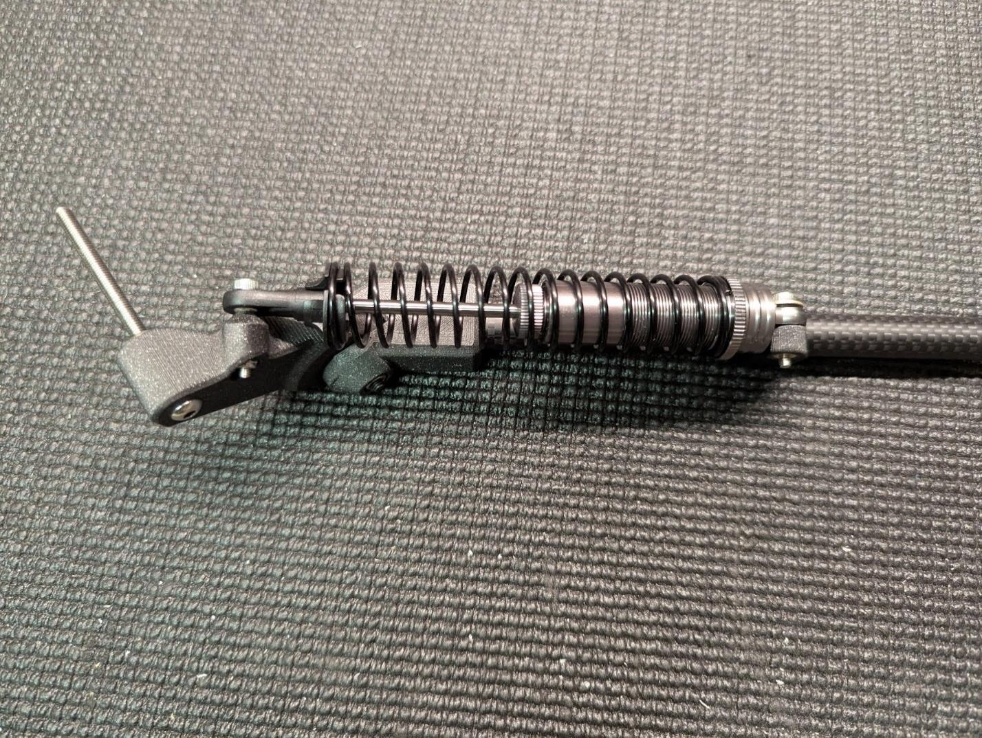 Shock absorber mounted to the gear arm